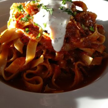 Nuovo Bistro - Taglietelli Napoletano  Braised beef short ribs, pork ribs, veal, herb cream fraiche, tomato sauce - Italian Near Me - Edmonton, Alberta