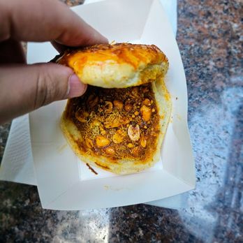 Manu's Dabeli Station - Garlic Dabeli. $7.99. Crunchy, spicy, aromatic, and very flavorful. Would recommend heavily if you can handle heat - Street Vendors Near Me - New York, New York Manu's Dabeli Station - Garlic Dabeli. $7.99. Crunchy, spicy, aromatic, and very flavorful. Would recommend heavily if you can handle heat - Street Vendors Near Me - New York, New York