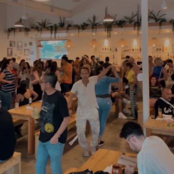 Lulu’s - a large group of people in a cafeteria - Cocktail Bars Near Me - Austin, Texas