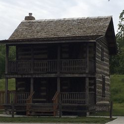 Olde Towne Park - A restored 1800s cabin is across the street from the park sign.