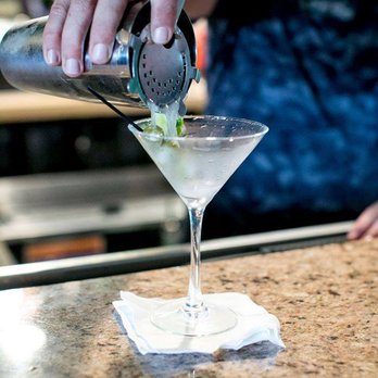 Legends - a bartender pouring a martini at a bar - Burgers Near Me - Lafayette, Louisiana