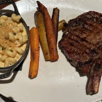 J. Gilbert's Wood-Fired Steaks & Seafood - 18 ounce ribeye with roasted carrots and lobster Mac and cheese - Steakhouses Near Me - Overland Park, Kansas