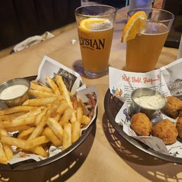 Fries, hush puppies, and Blue Moon beers. Fries, hush puppies, and Blue Moon beers.