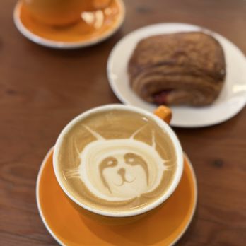 Cinderella Bakery & Cafe - Trash Panda almond milk latte and a cherry croissant on my day off. - Russian Near Me - San Francisco, California