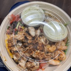 Twisted Fresh - West Coast chicken bowl with quinoa and shrimp added. With avocado lime sauce. Before I took the lid off. I got it to go today