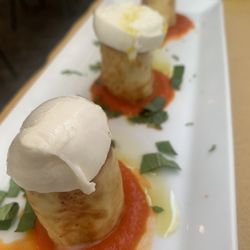 Osteria La Sosta di Violante - Pastry filled with eggplant topped with mozzarella in a bed of tomato sauce.