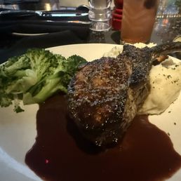 Entree special: bone-in pork chop with a cherry brandy sauce, mashed potatoes, and steamed broccoli.