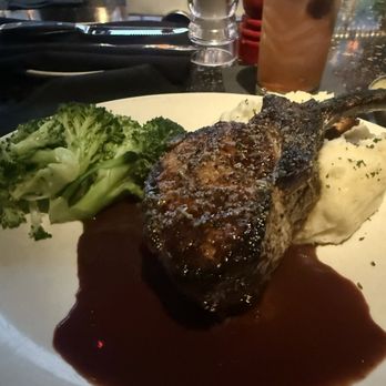 Stoney River - Entree special: bone-in pork chop with a cherry brandy sauce, mashed potatoes, and steamed broccoli. - Steakhouses Near Me - Atlanta, Georgia
