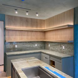 Lignum Custom Woodwork - Modern kitchen with floating wood shelves & integrated LED lighting . A sleek & functional design.