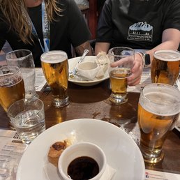 a table full of beer and food a table full of beer and food