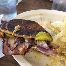 Under cooked grits burnt bread on sandwich Under cooked grits burnt bread on sandwich