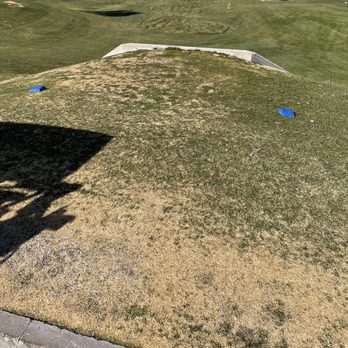 Desert Willow Golf Course - Downhill slope towards the concrete barrier and then rounded between the tee box. - Golf Near Me - Henderson, Nevada Desert Willow Golf Course - Downhill slope towards the concrete barrier and then rounded between the tee box. - Golf Near Me - Henderson, Nevada