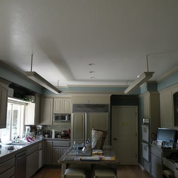 ReBuild Green - a kitchen with white cabinets and light blue walls - General Contractors Near Me - Palo Alto, California ReBuild Green - a kitchen with white cabinets and light blue walls - General Contractors Near Me - Palo Alto, California