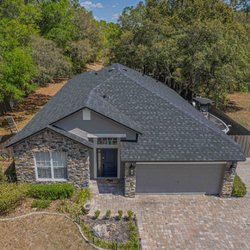 Stanley's Roofing - Aerial view of a recently completed shingle roof installation by Stanley's Roofing in Sorrento, FL...