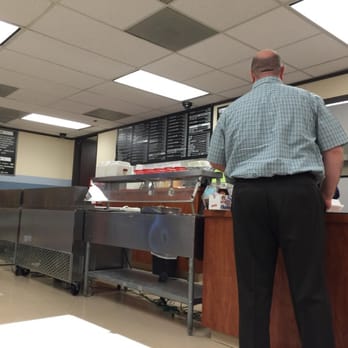 Grace Cafe - a man standing at the counter - Delis Near Me - Houston, Texas Grace Cafe - a man standing at the counter - Delis Near Me - Houston, Texas