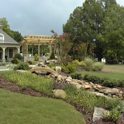 FLD Landscaping & Garden Shop - We built this winding stream bed as part of a sprawling backyard retreat.