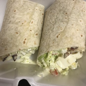 Corner Cafe & Grill - Egg Salad Wrap top view. Notice if you look closer how much it's already leaking and how watery it looks. - Delis Near Me - Somerset, New Jersey Corner Cafe & Grill - Egg Salad Wrap top view. Notice if you look closer how much it's already leaking and how watery it looks. - Delis Near Me - Somerset, New Jersey