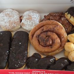 Town Donuts And Breakfast - Chocolate long johns, apple fritter, cinnamon Roll, chocolate twist, powdered sugar donut and a powdered sugar with raspberry filling