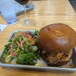 Fried chicken sandwich with a side salad ($3 upcharge) and my double coffee stout behind it