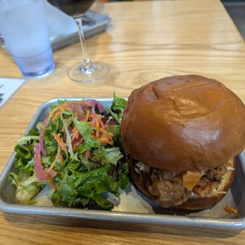 Common Roots Brewing - Fried chicken sandwich with a side salad ($3 upcharge) and my double coffee stout behind it - Breweries Near Me - Albany, New York