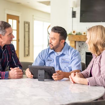 Chapman Heating, Air Conditioning, Plumbing, and Electrical - Chapman team member reviewing system options with customers to ensure the right system for their home. - Heating & Air Conditioning/HVAC Near Me - Bloomington, Indiana Chapman Heating, Air Conditioning, Plumbing, and Electrical - Chapman team member reviewing system options with customers to ensure the right system for their home. - Heating & Air Conditioning/HVAC Near Me - Bloomington, Indiana