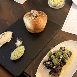 Parker House roll with seasonal butter, Woodfired Waggy beef steers and popcorn. Parker House roll with seasonal butter, Woodfired Waggy beef steers and popcorn.