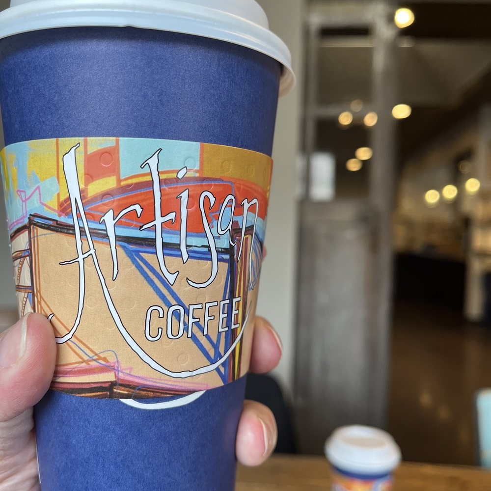 Artisan Coffee - a hand holding a cup of coffee - Coffee & Tea Near Me - Akron, Ohio