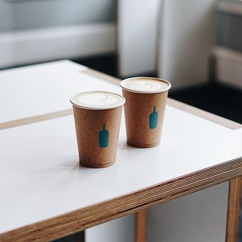 Blue Bottle Coffee - Old Oakland - two coffee cups on a table - Coffee & Tea Near Me - Oakland, California Blue Bottle Coffee - Old Oakland - two coffee cups on a table - Coffee & Tea Near Me - Oakland, California