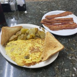 Western Omelette, home fries, toast and a side of bacon. Western Omelette, home fries, toast and a side of bacon.