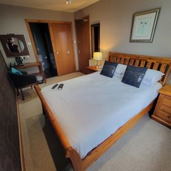 A room with a double bed and a side sea view