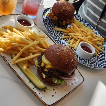Glasshouse Kitchen - Glasshouse burger, fries and the ahumado cocktail. Chicken sandwich, fries and a raspberry sparkler mocktail - Pizza Near Me - Research Triangle, North Carolina