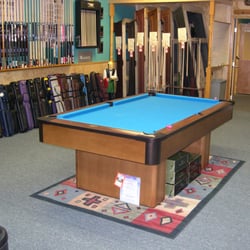 Charleston Billiards & Cue - Our Olhausen "Play Table" and some of the cues, cases, and tables that we stock.
