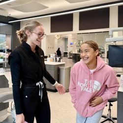 White Orthodontics - A White Orthodontics Ortho Coach praises a patient after her initial braces appointment.