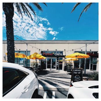Poke2 Grill - the outside of a restaurant with yellow umbrellas - Poke Near Me - Downey, California
