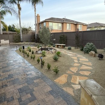 Santiago's Landscaping - The after, new pavers, new flagstone walkway with DG, new plants irrigation, lighting, boulders - Landscaping Near Me Santiago's Landscaping - The after, new pavers, new flagstone walkway with DG, new plants irrigation, lighting, boulders - Landscaping Near Me