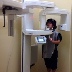 Eduardo M Gabuten & Associates - Noah Phillips taking dental  x-rays. The machine rotates around the patients head. No more ouchie film x-ray:)