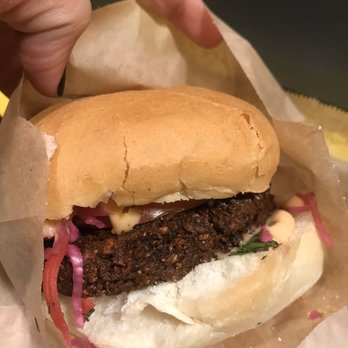 Saus - Cauli-falafel sandwich (house-made cauliflower falafel patty + pickled cabbage + tomato + bread 'n butter pickles + garlic chickpea mayo) - Vegetarian Near Me - Somerville, Massachusetts