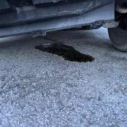 Kost Tire & Muffler - The aftermath of my botched oil change.  The little bit of my remaining oil leaked out into my driveway when it arrived.
