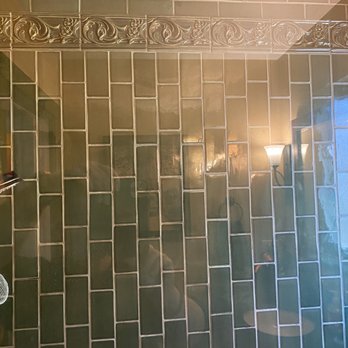Kokopelli Tile - Bathroom shower detail. It's perfectly vertically aligned, the photo is at an angle. - Tiling Near Me