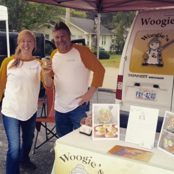 Woogie Foods - a man and a woman standing under a tent - Specialty Food Near Me Woogie Foods - a man and a woman standing under a tent - Specialty Food Near Me