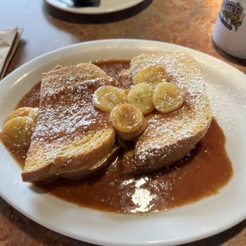 Huckleberry's Breakfast & Lunch - French Quarter French Toast (2)with bananas foster topping. - Cajun/Creole Near Me - Keller, Texas