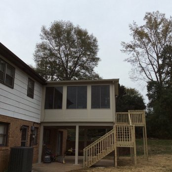 RealPro - the back of a house with a staircase leading up to the second floor - General Contractors Near Me - Ocean Isle Beach, North Carolina