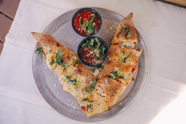 Photo of V Pizza - San Marco - Jacksonville, FL, US. The V Stromboli - crispy, cheesy goodness. 

If you don't tend to love the not so crispy nature of a neopolitan pizza - give this a try!