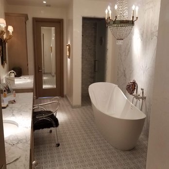 VersaTile - a bathtub in a bathroom with a chandelier - Flooring Near Me VersaTile - a bathtub in a bathroom with a chandelier - Flooring Near Me