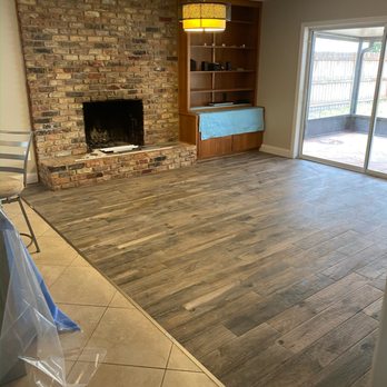 CB Stone & Tile - a living room with a fireplace - Flooring Near Me