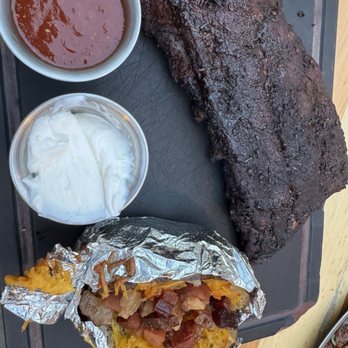 Woodshed Smokehouse - Ribs and loaded potato - Smokehouse Near Me - Fort Worth, Texas