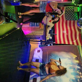 Tomfoolery Lounge - 3 women singing kareoke at Tomfoolerys, 2 are sharing a microphone for support but there are 3 mics available - Sports Bars Near Me - Largo, Florida
