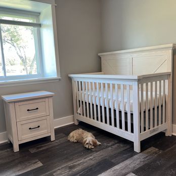 GoBa Elite Builders - a white crib in a bedroom - General Contractors Near Me GoBa Elite Builders - a white crib in a bedroom - General Contractors Near Me