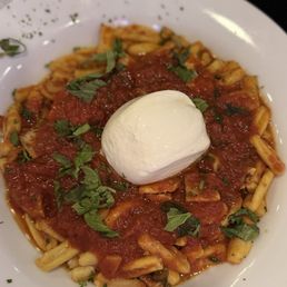 Cavatelli pasta in a ragu sauce with burrata