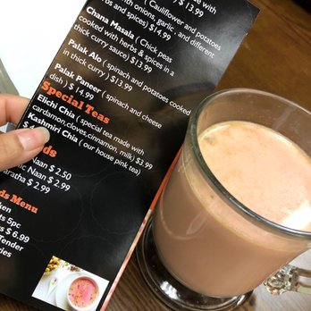 Four Sisters Kabob & Curry - a person holding a menu - Pakistani Near Me - Stevensville, Maryland Four Sisters Kabob & Curry - a person holding a menu - Pakistani Near Me - Stevensville, Maryland
